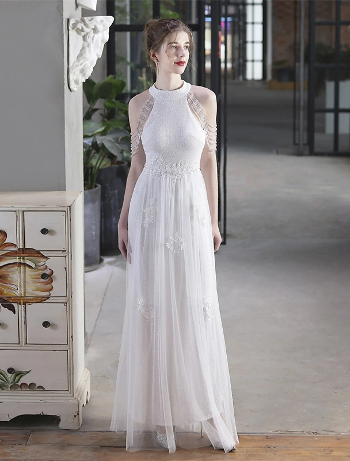 Model wearing a sparkling A-line high neck short sleeve floor-length sequin prom dress.