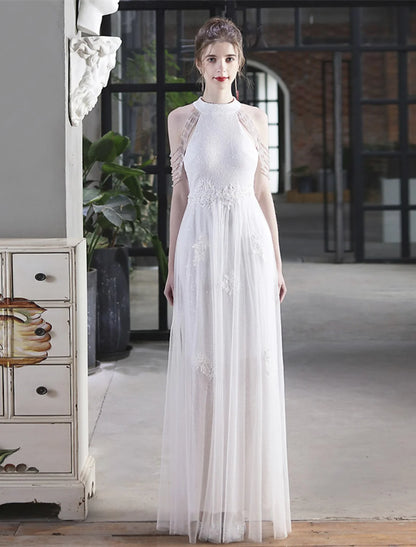 Back view of a model in a sparkling A-line floor-length prom dress.