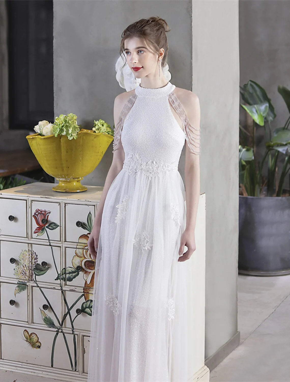 Side profile of a model in a high neck short sleeve A-line sequin dress.