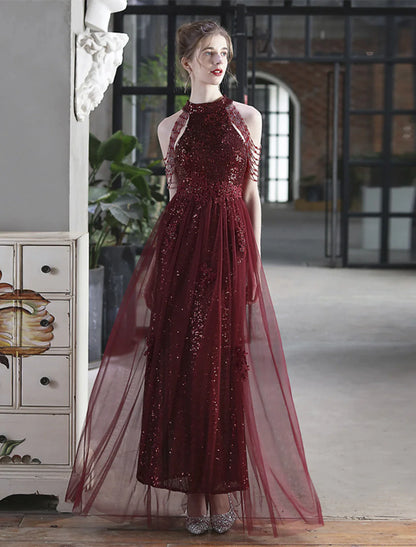 Model posing elegantly in a shimmering A-line floor-length prom gown.