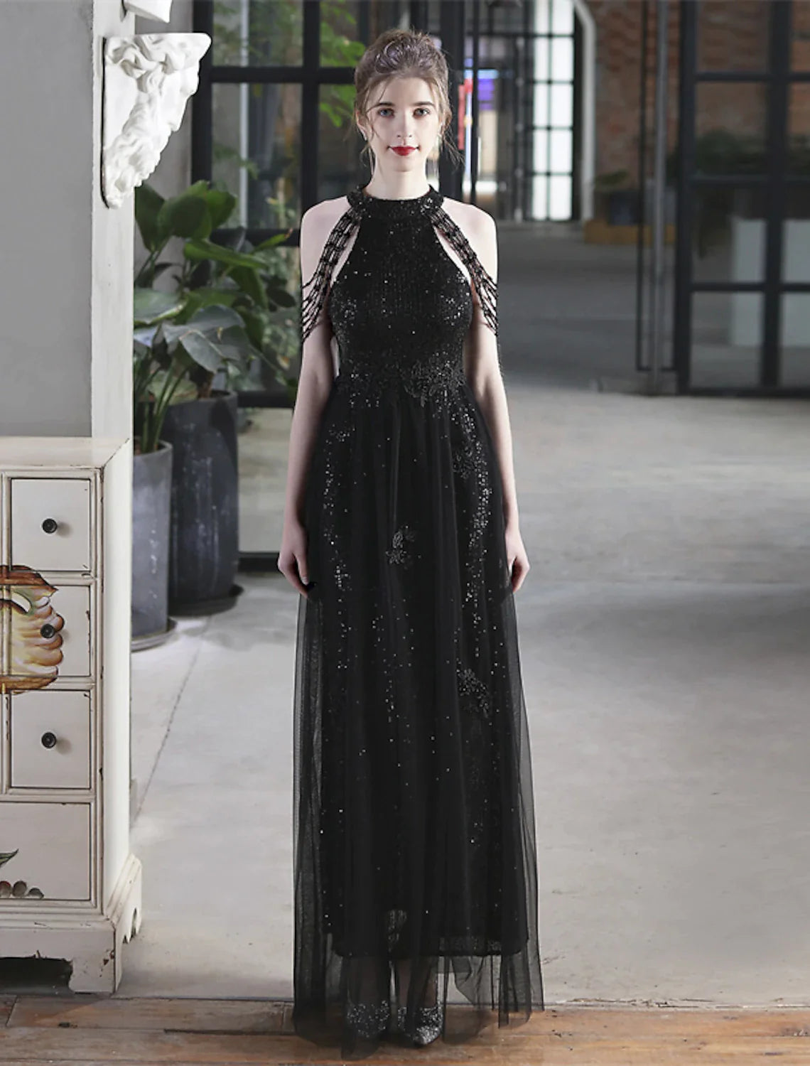 Detailed view of the short sleeve and sequin pattern on the A-line dress.