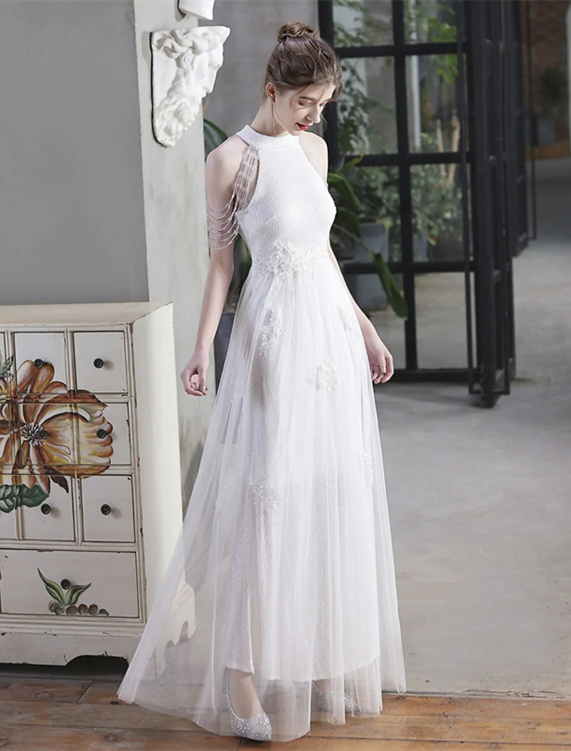 Another angle of a model in an elegant high neck sequin party dress.