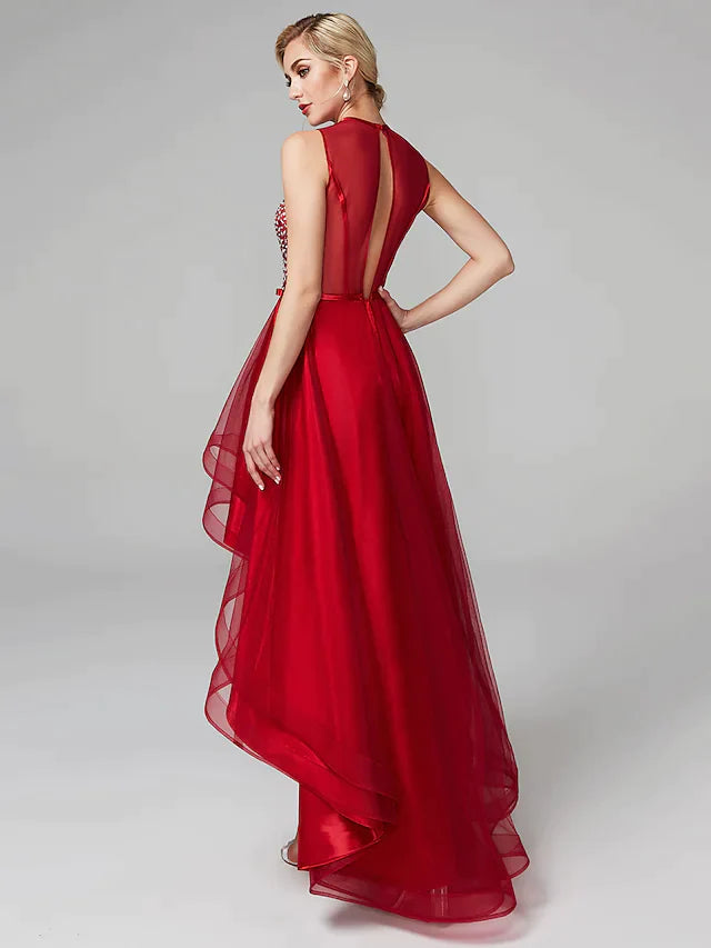 Side view of a woman in a sleeveless A-line high-low dress with tulle skirt.