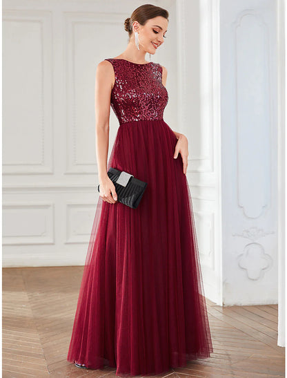 Model wearing a sparkling A-line jewel neck sequin tulle floor-length dress.