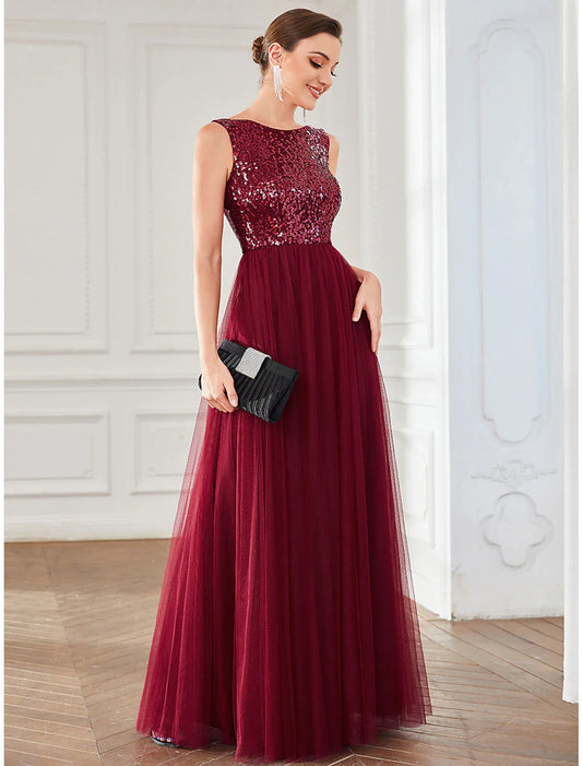 Model wearing a sparkling A-line jewel neck sequin tulle floor-length dress.