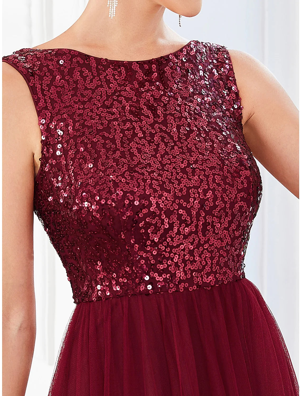 Side profile of the floor-length sequin tulle party dress.