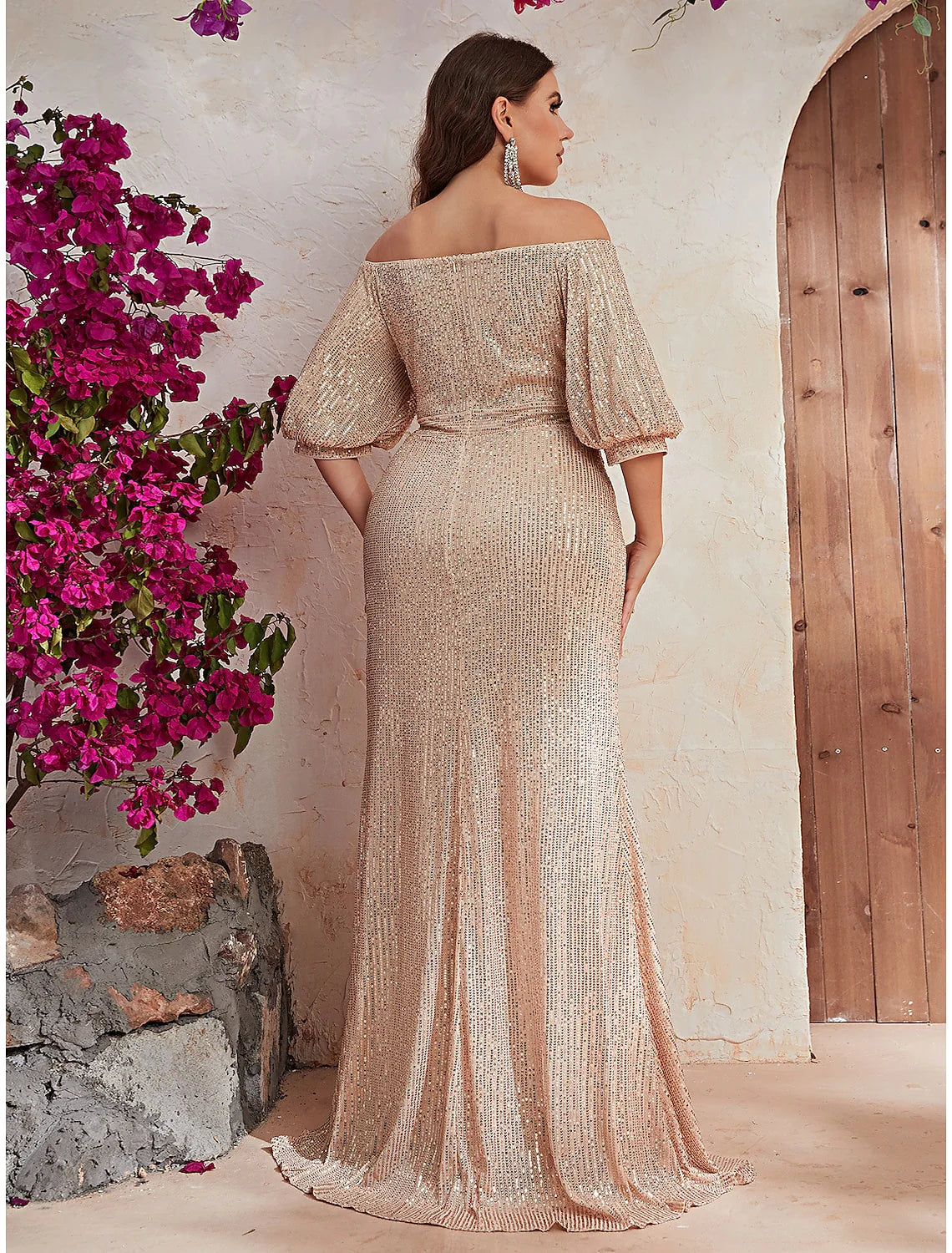 Close-up of the sparkling beaded bodice and half-sleeve of the off-shoulder A-line dress.