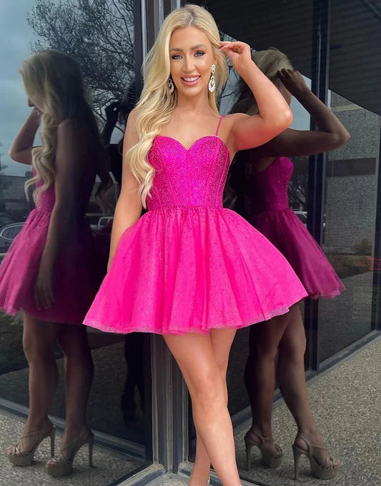 Model wearing a hot pink glitter homecoming dress with intricate beading.