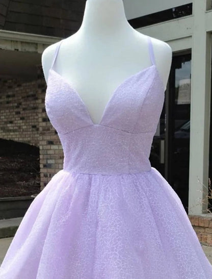 Side view of a woman wearing a glittery A-line mini dress with thin straps.