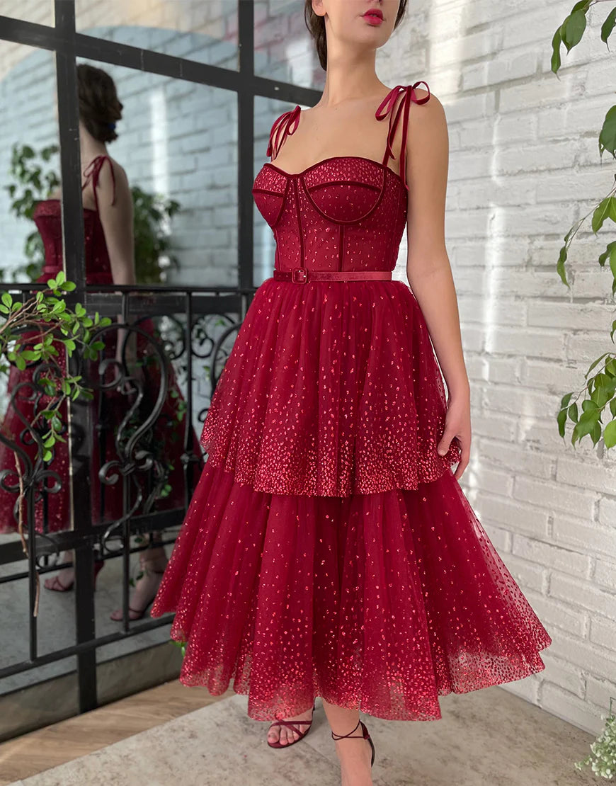 Model wearing a sparkling A-line tulle tea length prom dress.