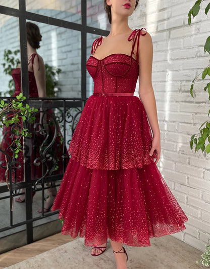 Model wearing a sparkling A-line tulle tea length prom dress.