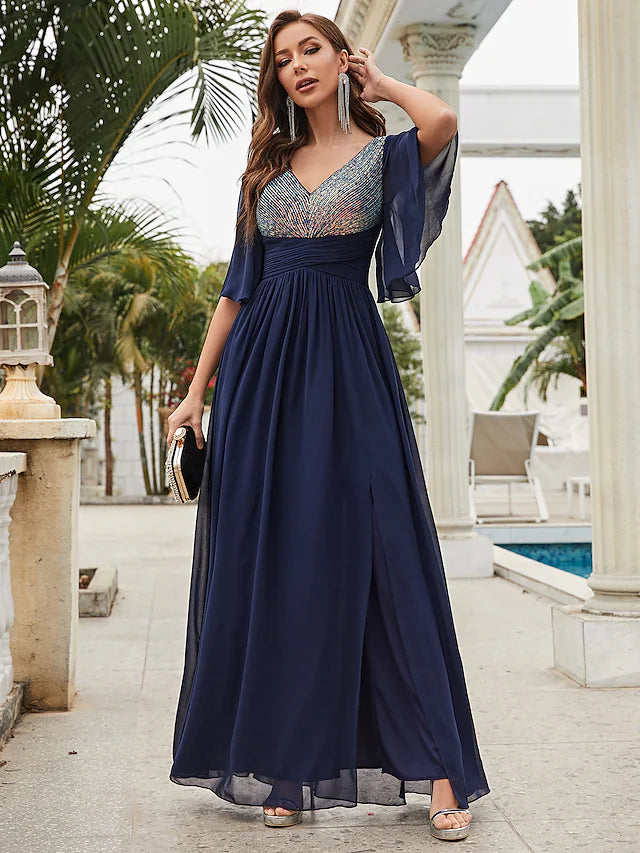 Woman modeling a sparkling A-line V-neck half sleeve chiffon gown.