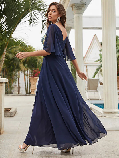 Close-up of the V-neck and half sleeves with crystal embellishments on the chiffon dress.