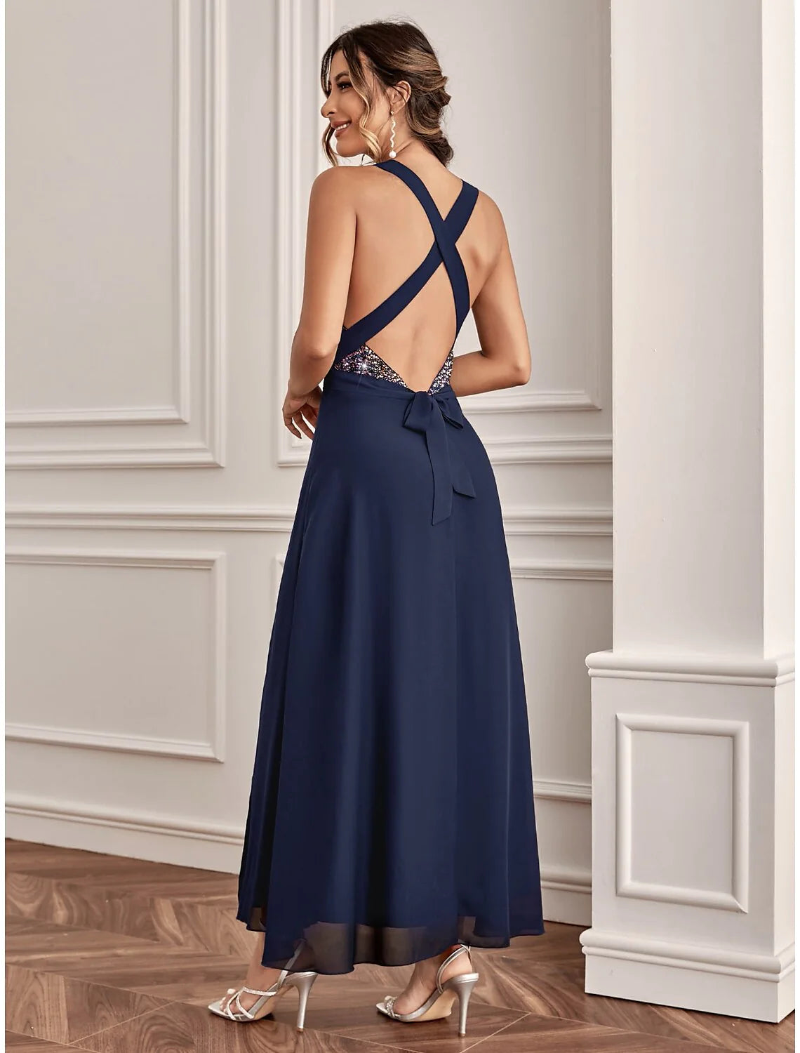 Side view of a model in a sequined A-line V-neck dress, showcasing the ankle-length cut.
