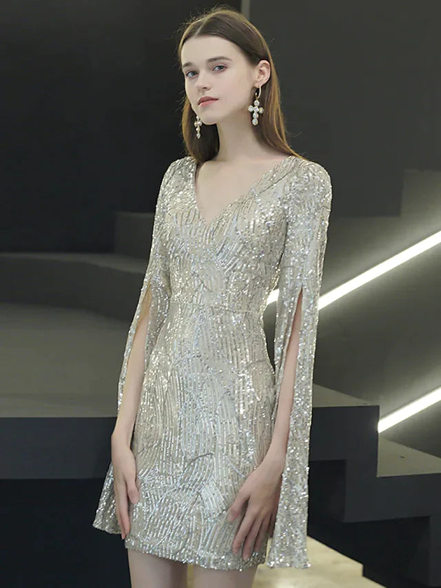 Woman posing in a sparkling V-neck long sleeve sequined mini dress.