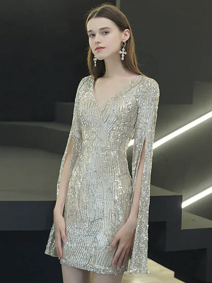 Woman posing in a sparkling V-neck long sleeve sequined mini dress.