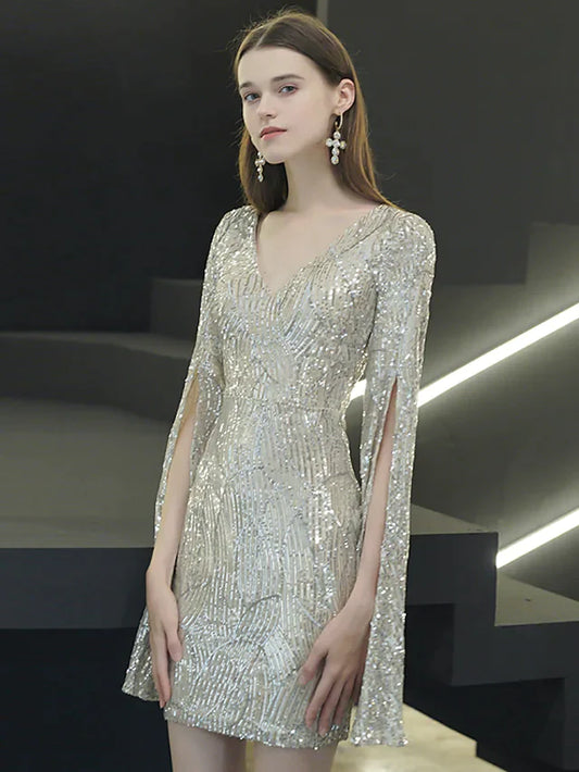 Woman posing in a sparkling V-neck long sleeve sequined mini dress.