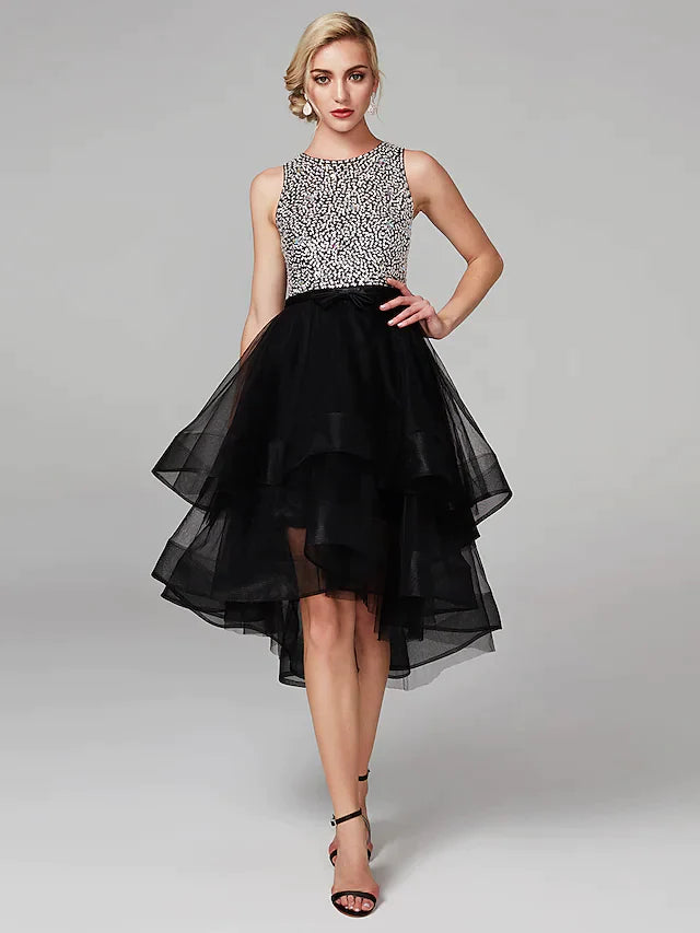 Model wearing a sparkling high-low ball gown with jewel neck and keyhole detail.