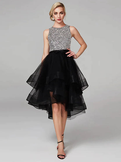 Model wearing a sparkling high-low ball gown with jewel neck and keyhole detail.