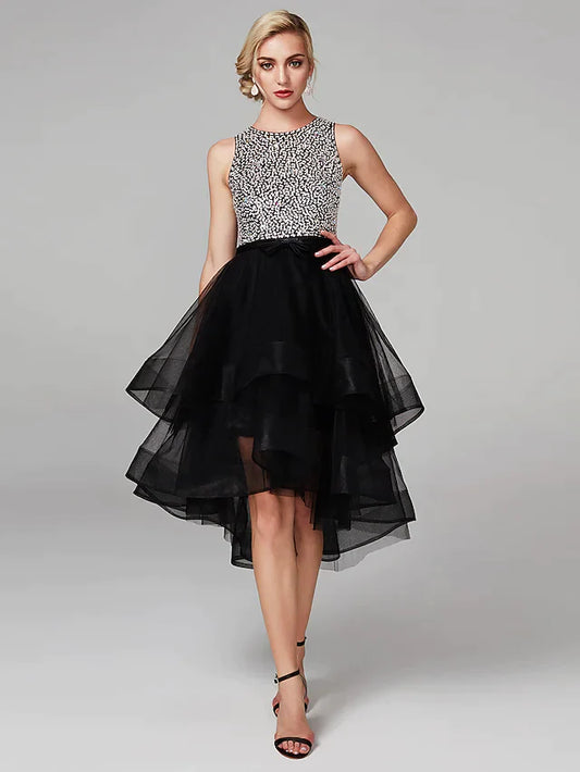 Model wearing a sparkling high-low ball gown with jewel neck and keyhole detail.