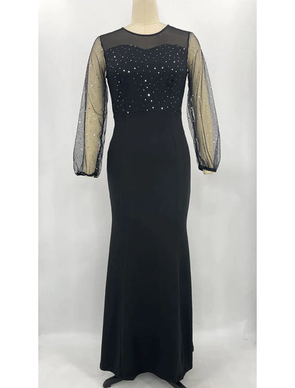Woman wearing a sparkling long sleeve jewel neck mermaid trumpet formal dress with rhinestone crystals.