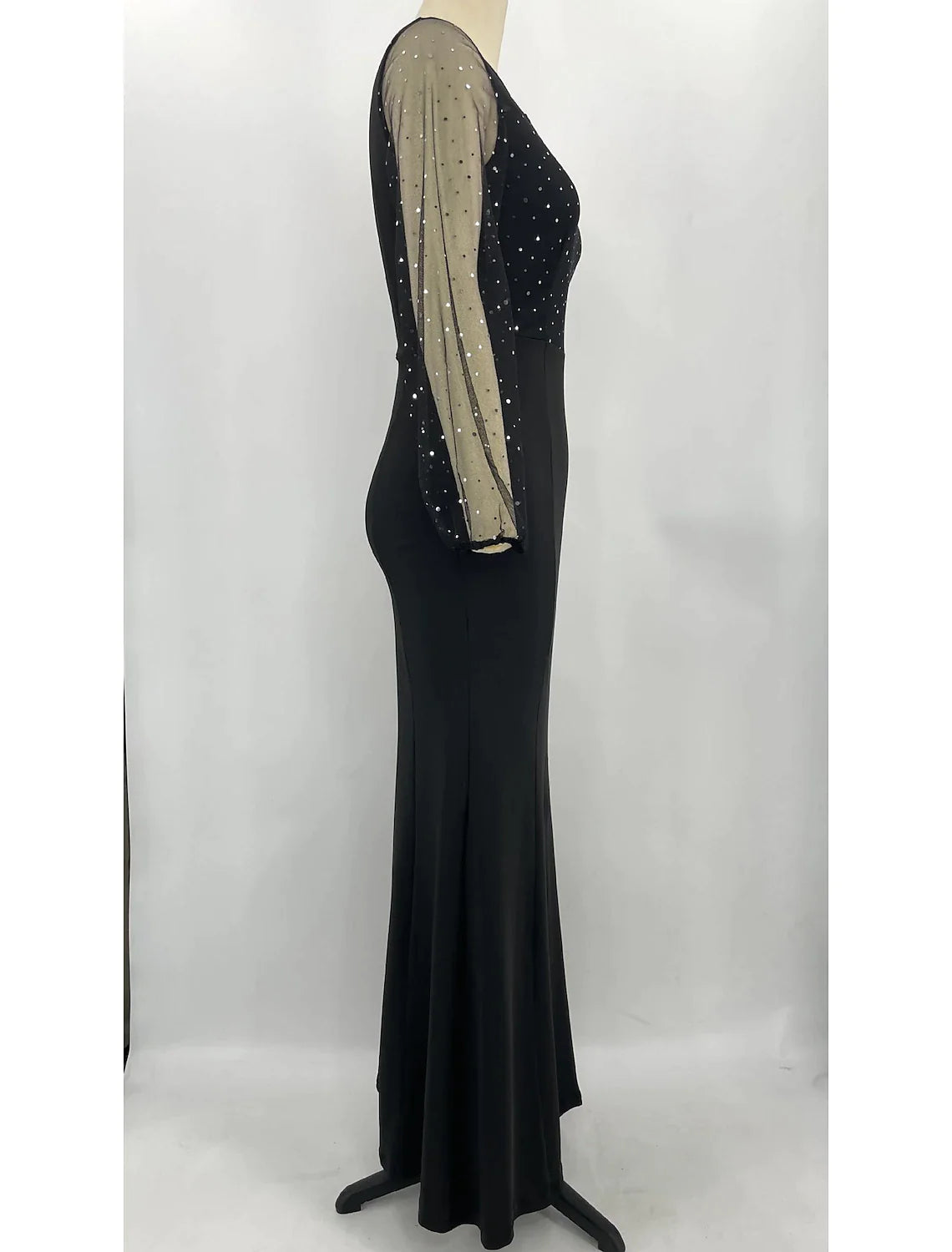 Back view of a woman in a sparkling long sleeve jewel neck mermaid trumpet formal dress.