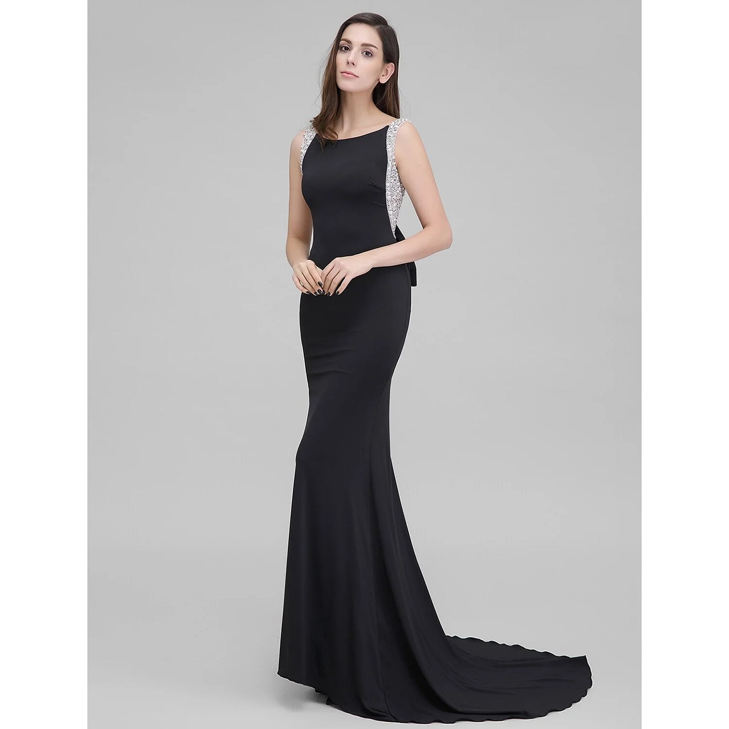 Full view of a sparkling mermaid trumpet formal evening dress with a scoop neck.