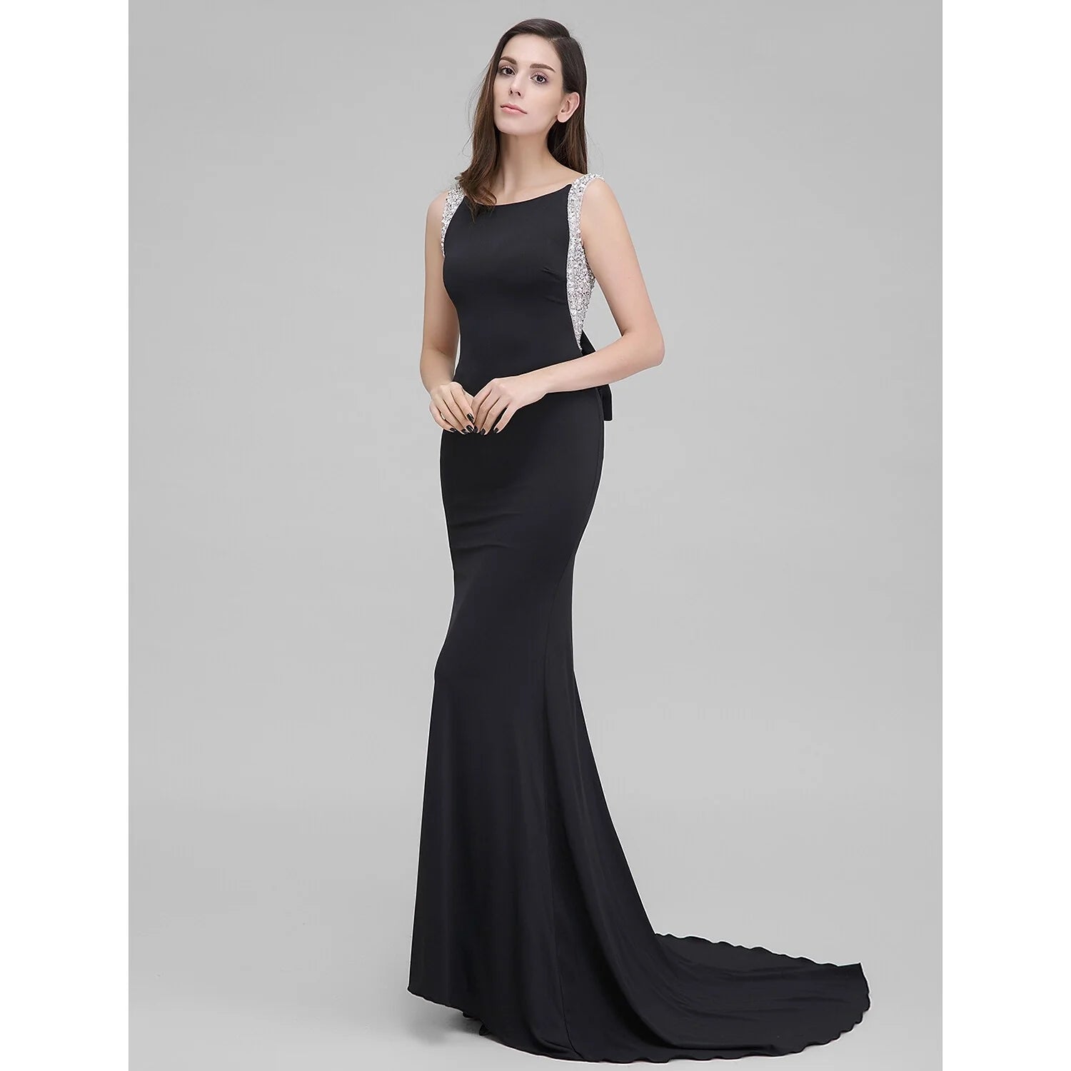 Full view of a sparkling mermaid trumpet formal evening dress with a scoop neck.
