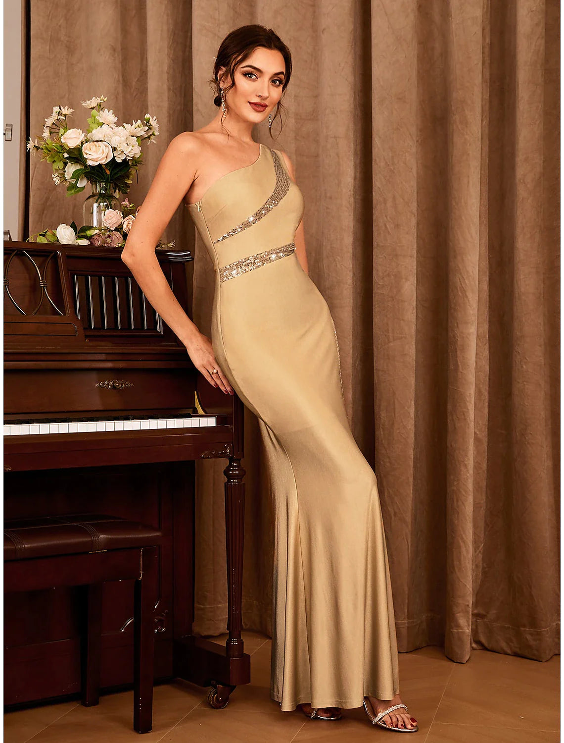 Back view of the elegant floor-length mermaid dress with one shoulder.