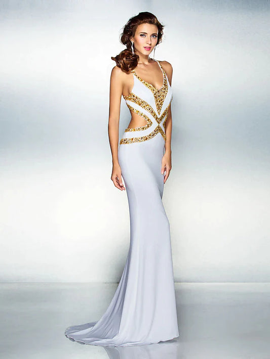 Model wearing a sparkling mermaid trumpet gown with a V-neck and crisscross back.