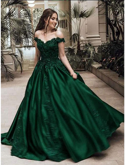 Sparkling off-shoulder ball gown with lace appliques.