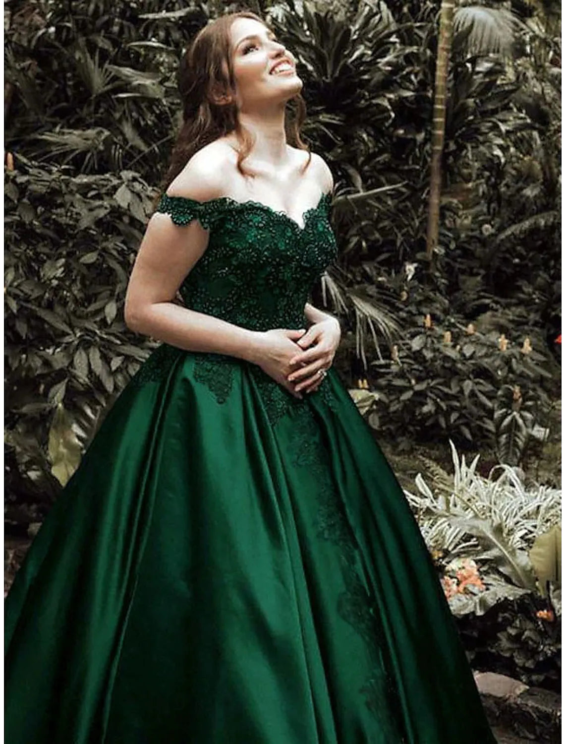 Back view of a floor-length prom dress with intricate lace detailing.
