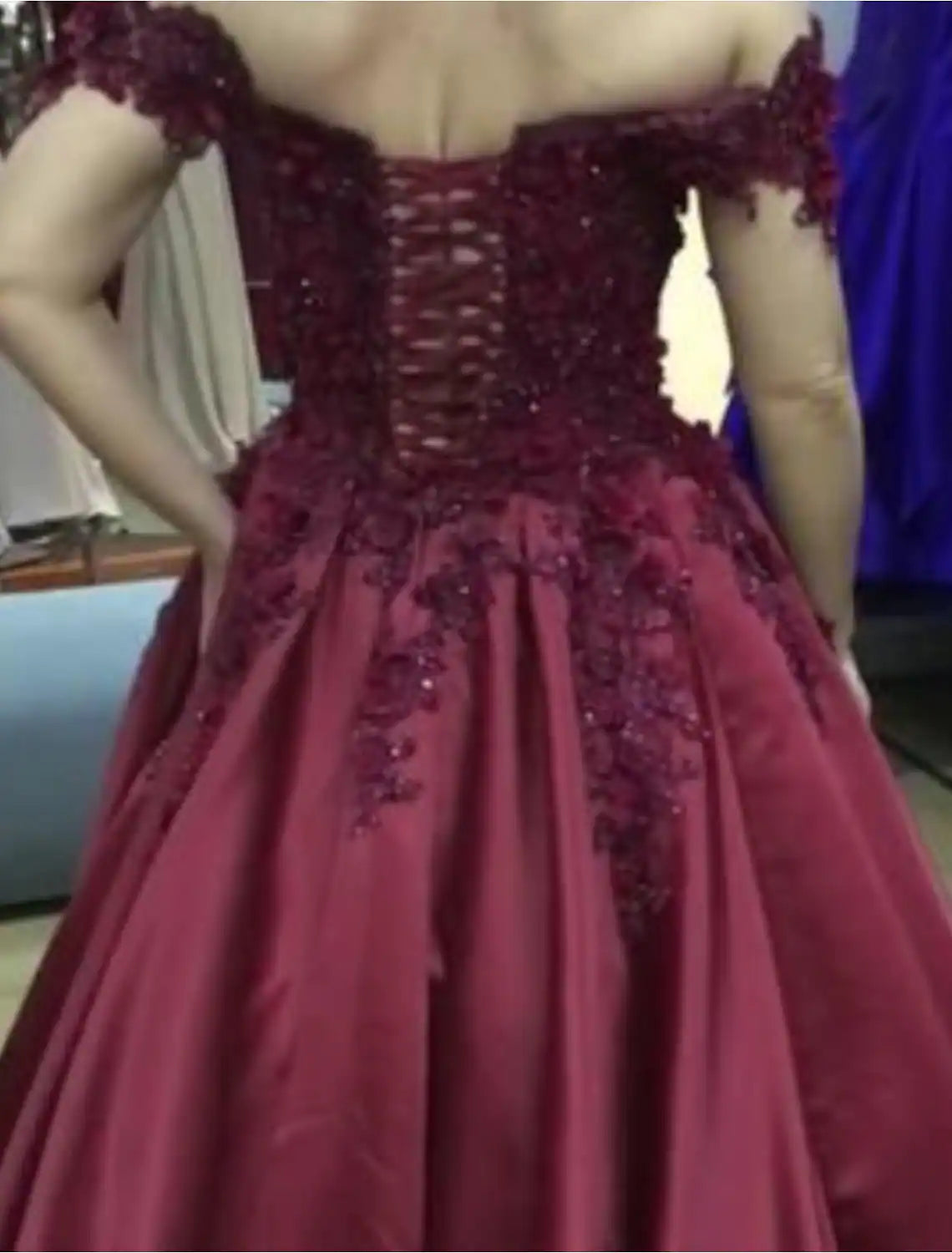 Close-up of lace appliques and sparkling details on a formal gown.