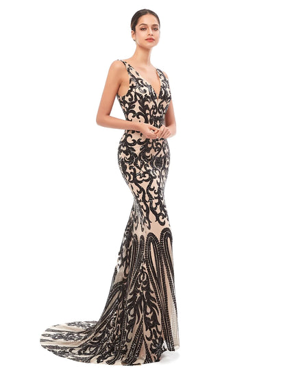 Model wearing a sparkling sequin tulle mermaid trumpet evening gown with a V-neck and court train.
