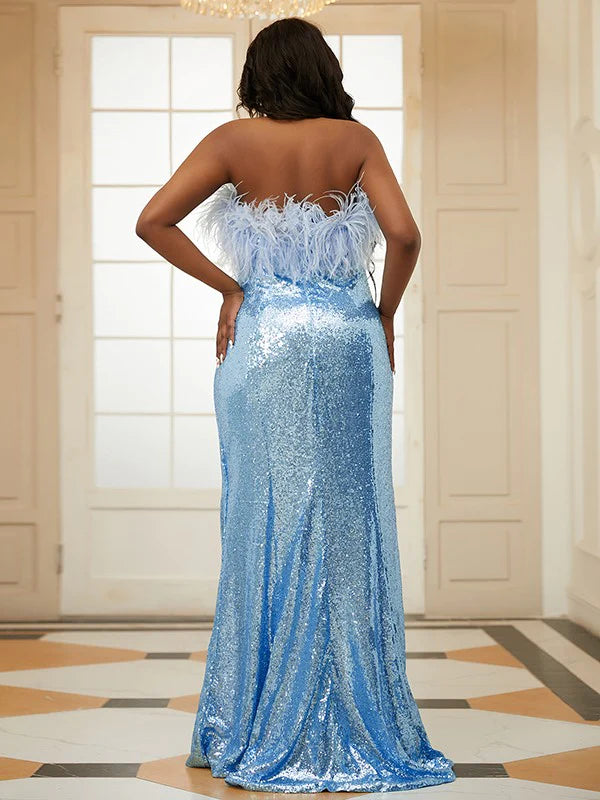 Side view of a woman in a strapless sequin and feather prom dress, showing the flowing skirt.