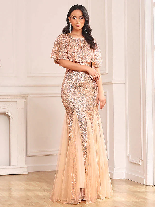 Full-length view of woman posing in sparkling two-piece mermaid prom dress.