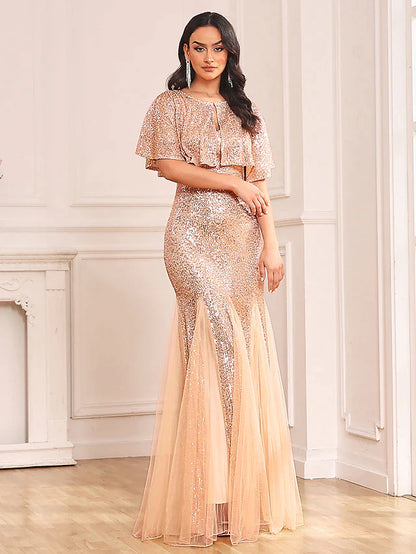 Full-length view of woman posing in sparkling two-piece mermaid prom dress.