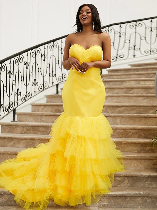 Yellow trumpet mermaid prom dress with sweetheart neckline and satin layers.