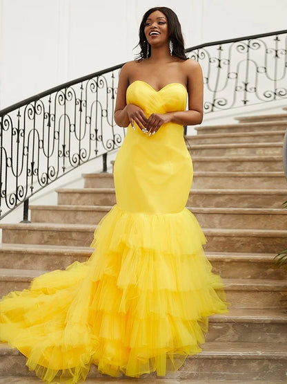 Yellow trumpet mermaid prom dress with sweetheart neckline and satin layers.