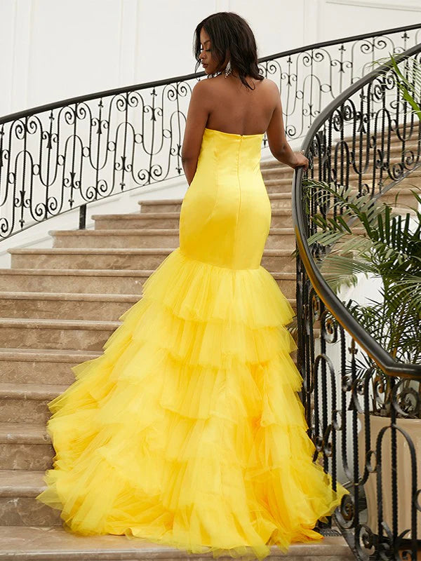 Side view of a yellow satin trumpet mermaid gown.