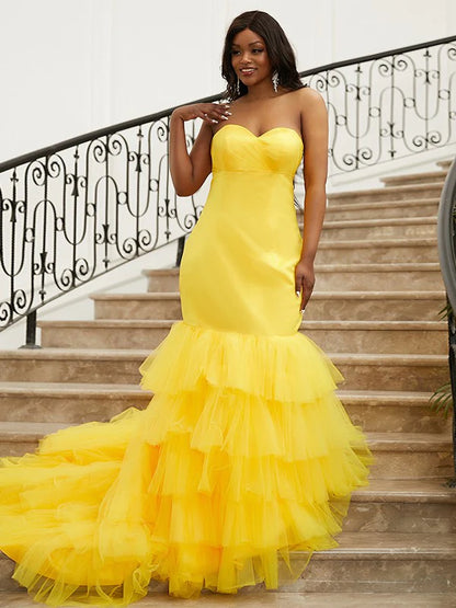 Back view of the elegant yellow prom dress, showcasing its train.