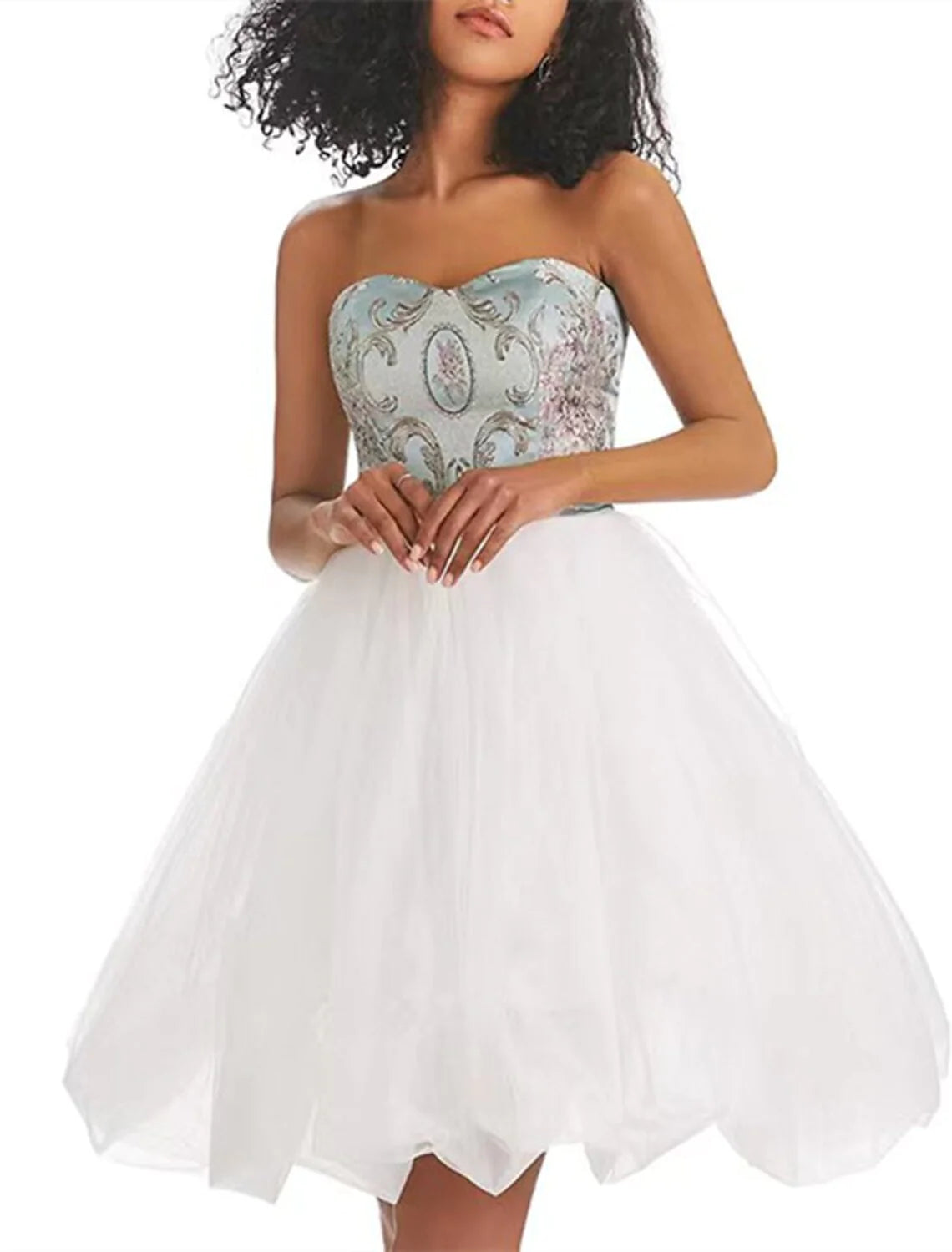 A woman standing in a vibrant A-line strapless color block tulle print short dress, side view.