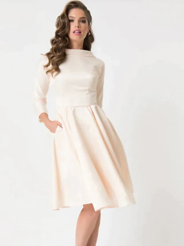 Full view of the white A-line knee-length wedding dress with long sleeves and jewel neck.