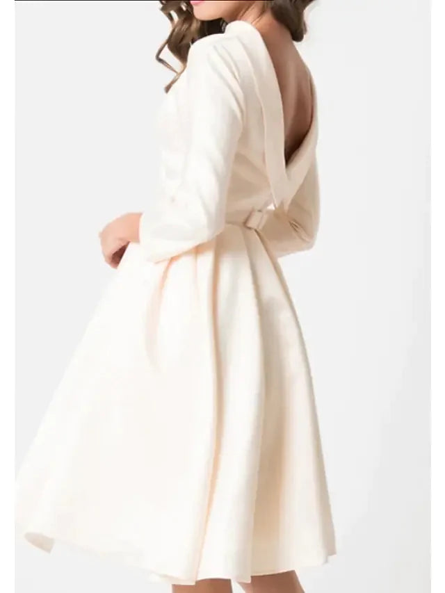 Back view of the white A-line knee-length wedding dress, showing the elegant silhouette.