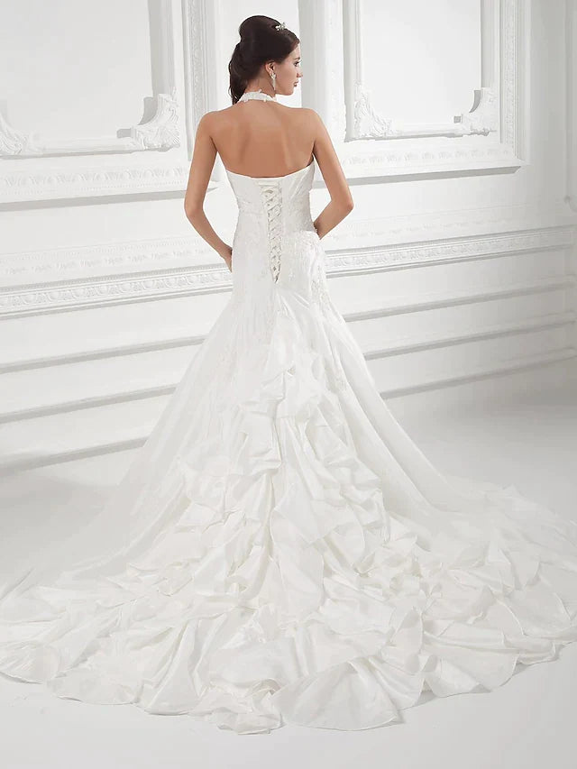 Close-up of halter neck and bodice with ruched taffeta and delicate beading.