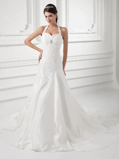 Back view of vintage A-Line wedding gown, highlighting the halter neck and train.