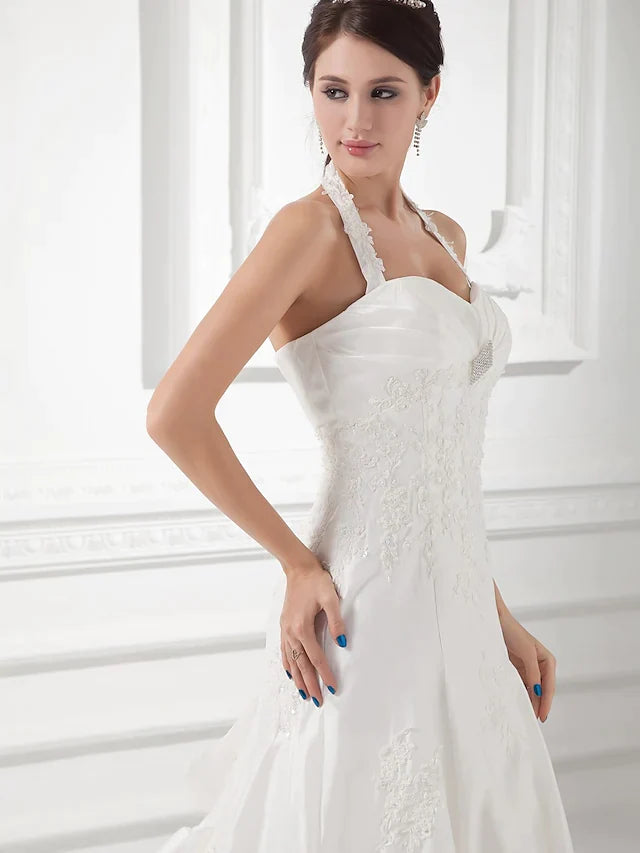 Full length view of a plus size A-Line wedding dress with spaghetti straps.